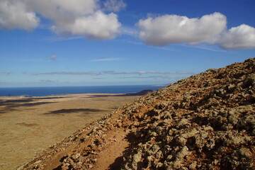 desertic landscape of volcano and caldera on the sea side