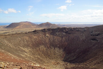 desertic landscape of volcano and caldera on the sea side