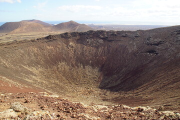 desertic landscape of volcano and caldera on the sea side