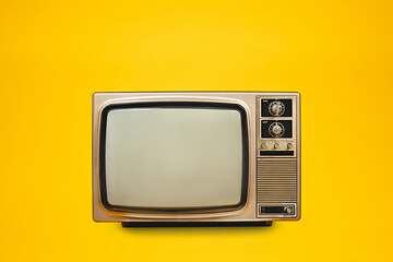 Vintage, retro old TV (television) with blank screen isolated on yellow background, front view, clipping path