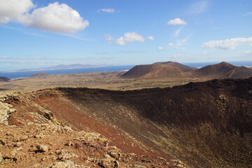 desertic landscape of volcano and caldera on the sea side