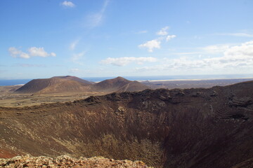 desertic landscape of volcano and caldera on the sea side