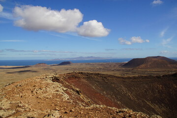 desertic landscape of volcano and caldera on the sea side