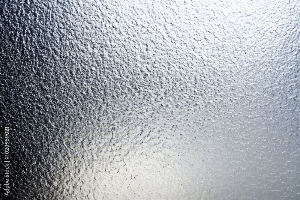 Poster a close-up view of a frosted glass surface with a smooth, matte finish