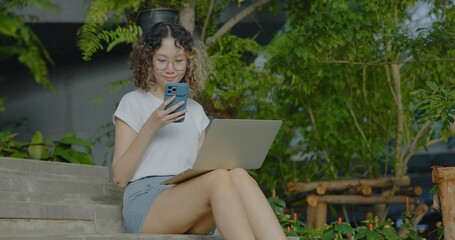Asian businesswoman working using laptop outdoors. Financial communication business. reading...