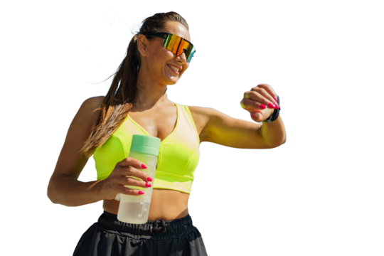 A Fitness Enthusiast Checks Her Smartwatch While Holding a Water Bottle Outdoors in Bright Sunny Weather