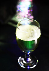 wine glass with some colored bokeh background and dark areas can be used as wallpaper or illustration image