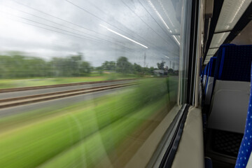 Passenger Train Window View During Daytime with motion blur