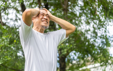 ick unhappy senior elderly man touching head serious depressed feeling headache thinking of...