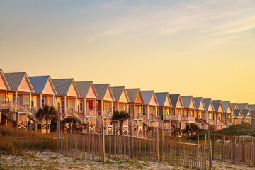 Row of beach houses at sunrise on St. George Island, a barrier island off the Florida Panhandle, late in October, for motifs of autumn, vacation, the Gulf Coast © Kenneth