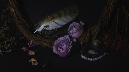 Beautiful magic set. Purple rose flowers, willow wreath, birds feather, bracelets, gems, dry herbs...