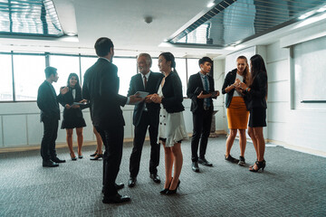 Many young businessmen and businesswomen in group meeting standing at conference hall in office. Multicultural company organization unity and support. Concept of partnership and human resources. uds