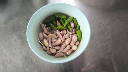 Chili and garlic in blue bowl on table