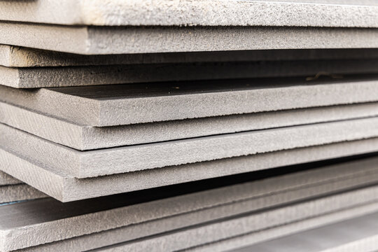Many sheets of rigid xps extruded polystyrene insulation boards are stacked and ready for use at a construction site. Selective focus