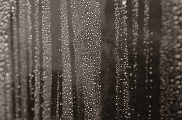 Rain droplets on dark background suitable for wallpaper decoration or design. Water droplets concept