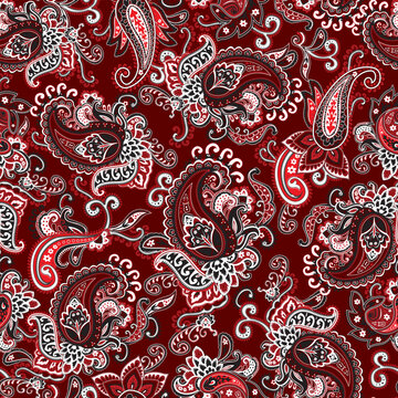 Seamless ornate red, black and white paisley pattern on a red background. Traditional batik flower motif for textile fabrics.