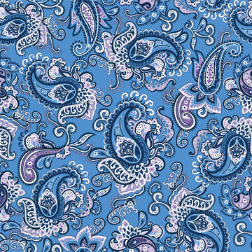 Seamless ornate navy blue and white Paisley pattern on a blue background. Traditional batik flower motif for textile fabrics.