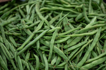 green beans displayed on a farmer's market counter