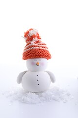 Cute decorative snowman and artificial snow isolated on white