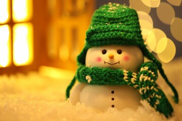 Cute decorative snowman on artificial snow against blurred lights, closeup