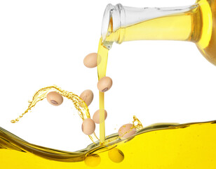 Vegetable oil and soy beans pouring from glass jug on white background
