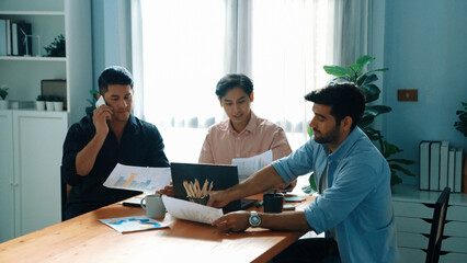 Professional businessman waking tired partner fall asleep or taking a nap while project manager calling phone and talking about marketing campaign. worker using phone to talk to investor. Convocation.