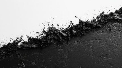 An abstract texture in black and white, showcasing a jagged edge where the two colors meet.