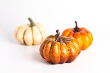 Three pumpkins on white background close up photo