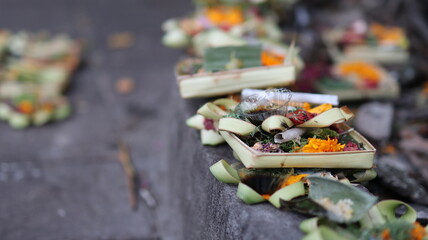 Canang Sari daily Offerings made by Balinese Hindus on the Ground of the streets of Bali