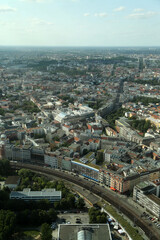 A panoramic view of Berlin's urban landscape featuring historic architecture and modern infrastructure under a clear sky at dusk