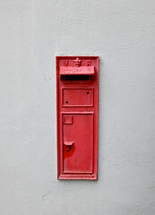Ancient red post box on wall