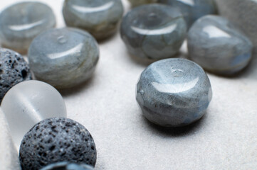 Close-up of beads for bracelet on gray background. Beautiful beads of blue and light blue colors