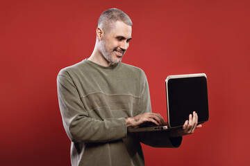 Smiling man holding a notebook