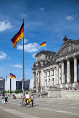 Obraz premium Berlin, Germany, July 29 2009, Visitors Explore the Reichstag Facade With German Flags in Berlin