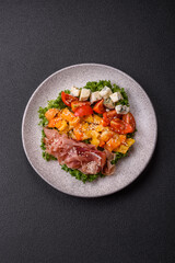 Appetizing salad with prosciutto, pumpkin, cheese and tomatoes