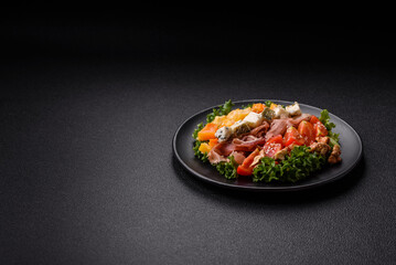 Appetizing salad with prosciutto, pumpkin, cheese and tomatoes
