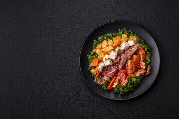 Appetizing salad with prosciutto, pumpkin, cheese and tomatoes