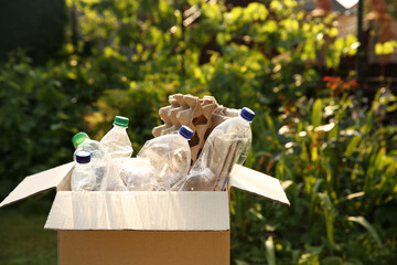 Recycling. Different garbage in cardboard box outdoors