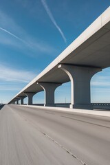 Large concrete overpass stretching into the distance under a clear sky.