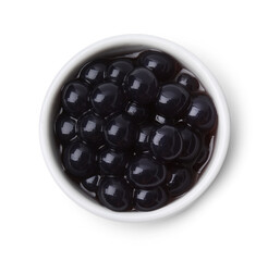 Dark tapioca pearls in bowl isolated on white, top view