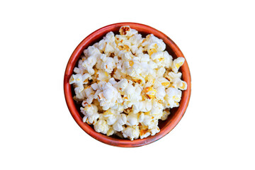 Pop corn in a clay bowl isolated on a white background top view