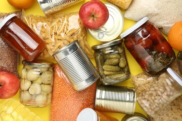 Food donation. Different products on yellow background, top view