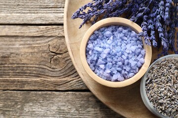 Natural sea salt and lavender on wooden table. Space for text