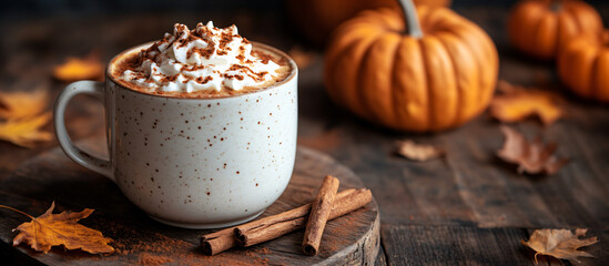 Mug with pumpkin drink, latte or cocoa on wood background. Design template harvest autumn menu with space for text.