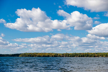 The distant shore along Lake Tomahawk in mid-September is starting to change in color, near Lake Tomahawk, Wisconsin