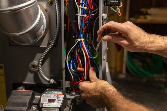 Electrician working on wires while installing a component on a smart home automation system. Selective focus