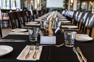 Elegant table setting is awaiting guests for a corporate event in a modern restaurant. Selective focus