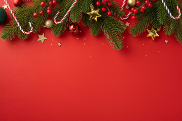 A vibrant red Christmas background featuring pine branches, candy canes, and golden stars, evoking...