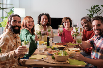 Group of friends having fast food dinner at home and enjoying good shared moments