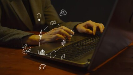 Animated symbols of the concept of green friendly energy and their sources against the background of a woman working on a laptop in the dark. The concept of reasonable consumption of resources. Cg